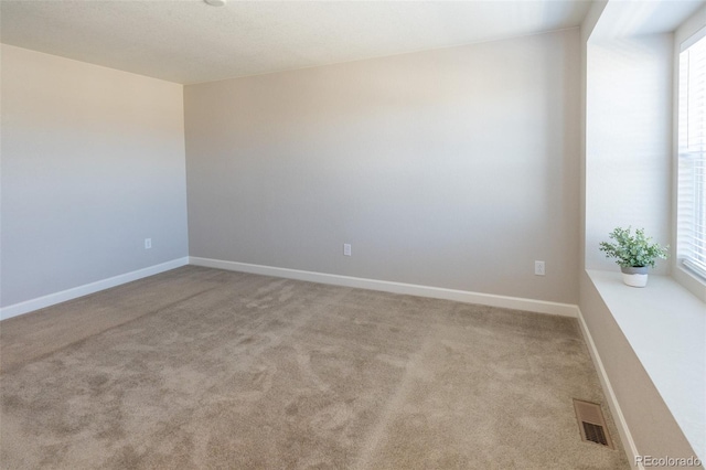 spare room featuring light colored carpet