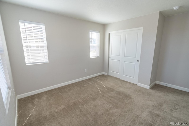 unfurnished bedroom with carpet and a closet