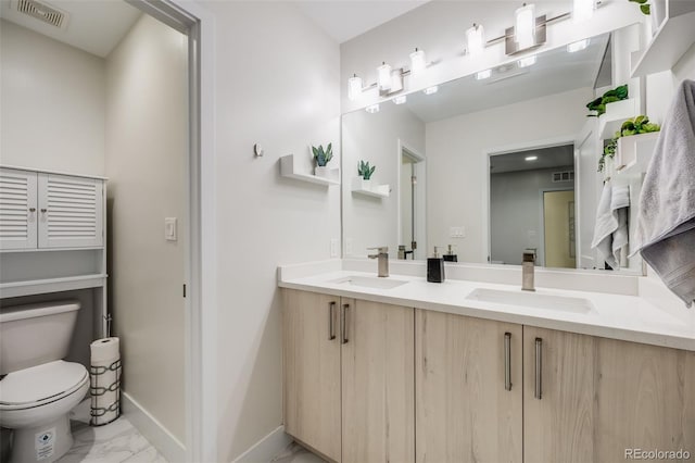 bathroom with marble finish floor, visible vents, toilet, a sink, and baseboards