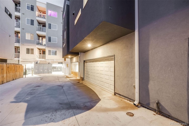 interior space with fence and stucco siding