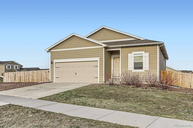 215 N Stewart St, Keenesburg, CO 80643 - view of front of house featuring driveway, a garage, and roof with shingles