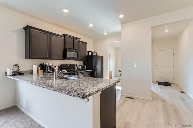 215 N Stewart St, Keenesburg, CO 80643 - kitchen featuring black appliances, dark brown cabinetry, a sink, baseboards, and recessed lighting