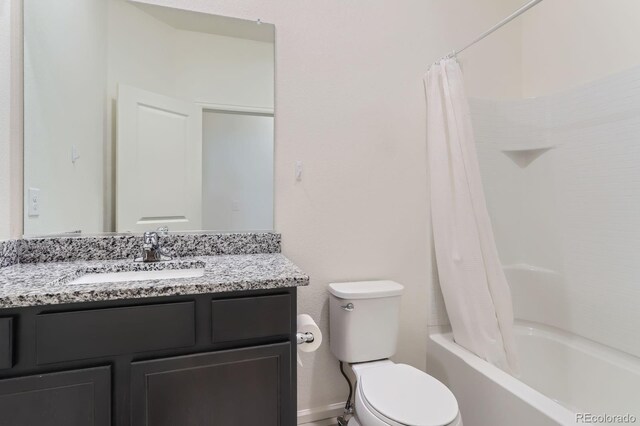 215 N Stewart St, Keenesburg, CO 80643 - bathroom with toilet, vanity, shower / bath combo, and baseboards