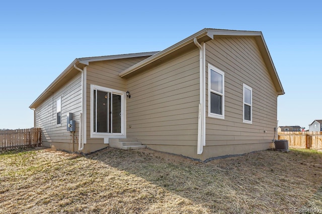 215 N Stewart St, Keenesburg, CO 80643 - rear view of house featuring fence and central air condition unit