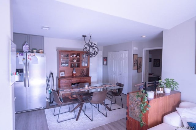 8200 E 8th Ave Unit 1203, Denver, CO 80230 - dining area featuring wood finished floors and a chandelier