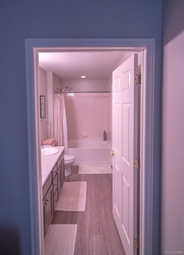 8200 E 8th Ave Unit 1203, Denver, CO 80230 - bathroom featuring vanity, shower / bath combination with curtain, and wood finished floors