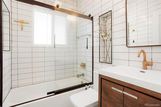 full bathroom with tile walls, backsplash, enclosed tub / shower combo, vanity, and toilet