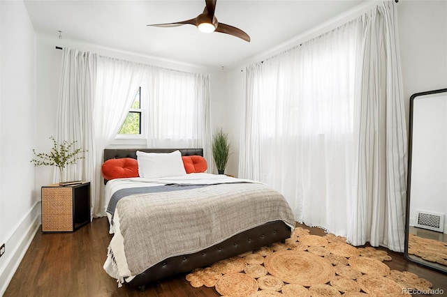 bedroom with ceiling fan and dark hardwood / wood-style flooring