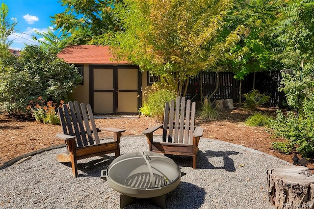 view of patio with a storage unit and an outdoor fire pit