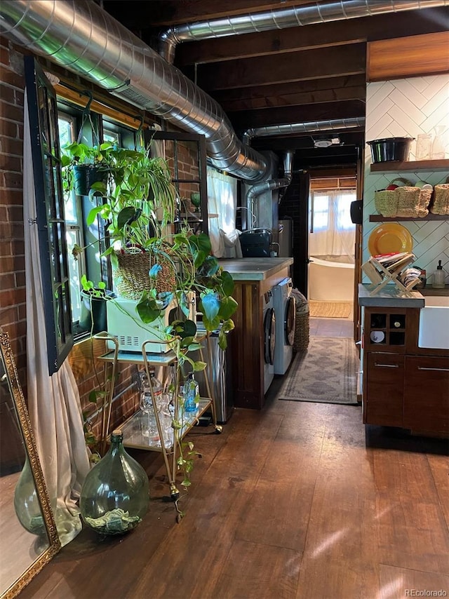 basement with dark wood-type flooring and independent washer and dryer