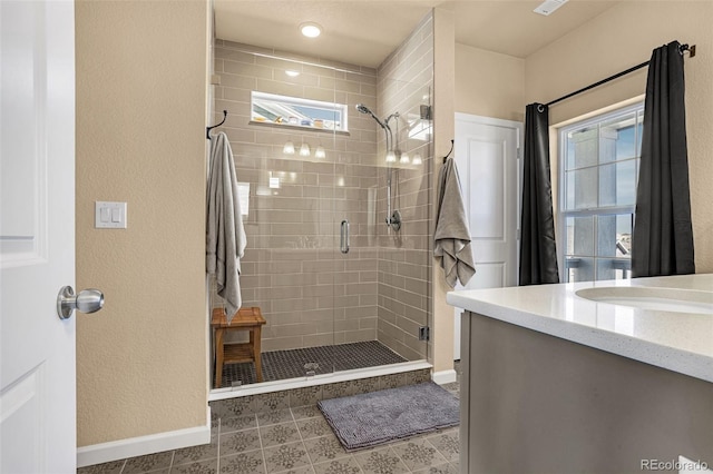 bathroom featuring an enclosed shower and vanity