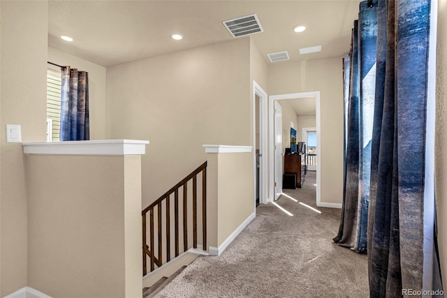 hallway with carpet flooring