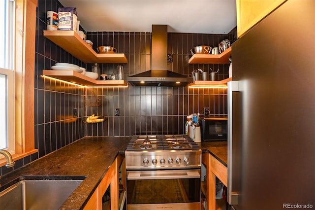 kitchen featuring sink, backsplash, stainless steel appliances, and wall chimney exhaust hood