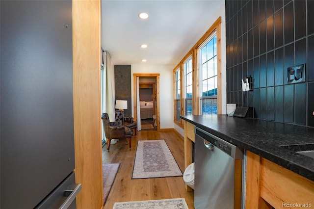 kitchen with fridge, stainless steel dishwasher, and light wood-type flooring