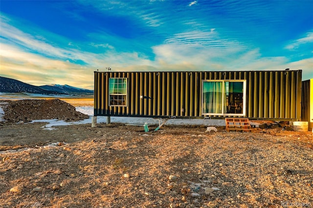 back house at dusk with a mountain view