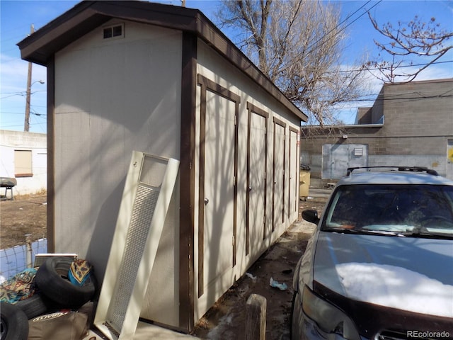 view of property exterior with an outbuilding