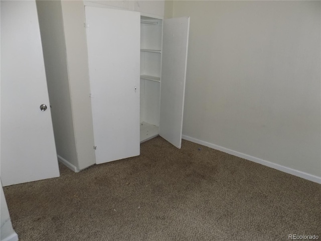 unfurnished bedroom featuring carpet floors and a closet