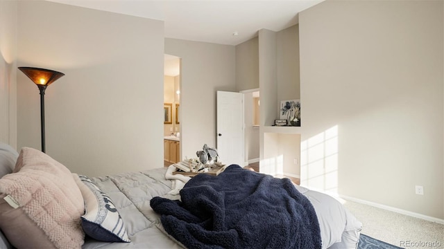 carpeted bedroom featuring connected bathroom