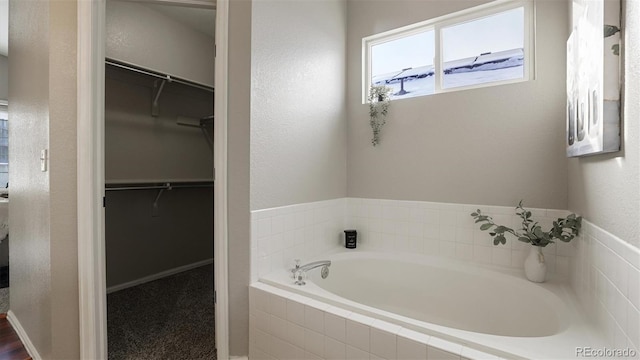 bathroom featuring tiled bath