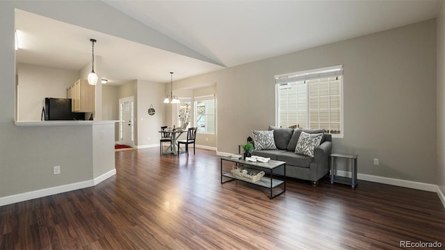 living room with vaulted ceiling and dark hardwood / wood-style flooring