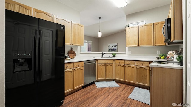 kitchen with pendant lighting, sink, appliances with stainless steel finishes, wood-type flooring, and vaulted ceiling