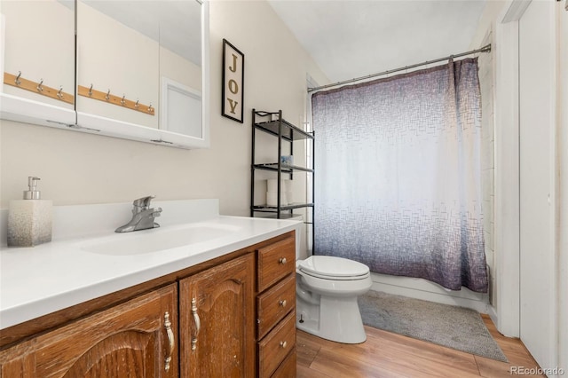 full bathroom featuring hardwood / wood-style flooring, vanity, toilet, and shower / bath combo with shower curtain