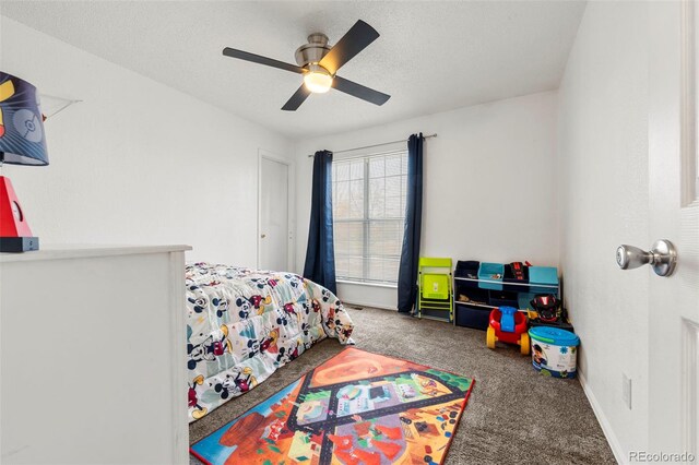 carpeted bedroom featuring a textured ceiling and ceiling fan