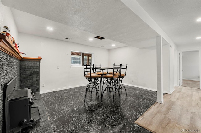 dining room featuring hardwood / wood-style floors and a textured ceiling