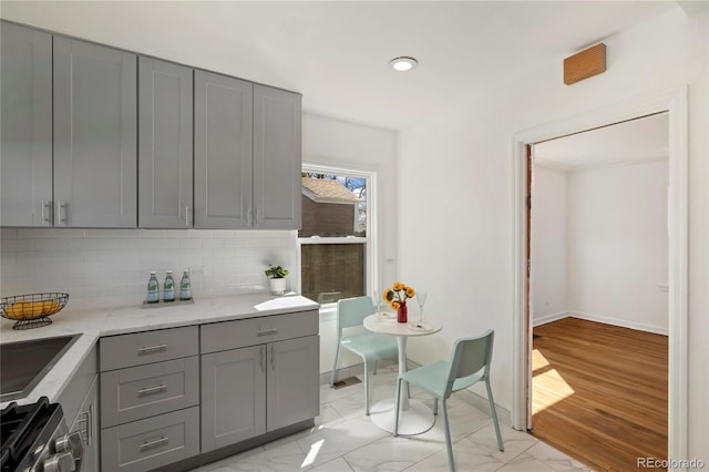 2570 Jay St, Edgewater, CO 80214 - kitchen featuring gray cabinets, stainless steel range with gas cooktop, decorative backsplash, baseboards, and recessed lighting