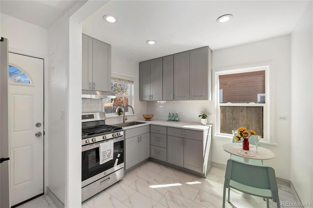 2570 Jay St, Edgewater, CO 80214 - kitchen with gray cabinets, gas stove, a sink, under cabinet range hood, and recessed lighting