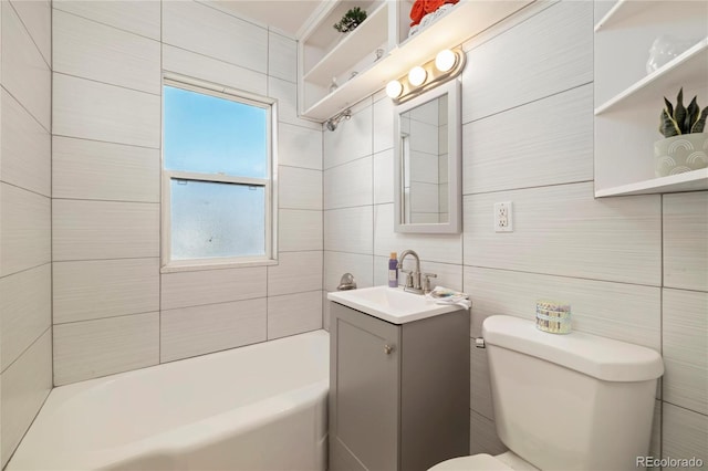 2570 Jay St, Edgewater, CO 80214 - full bath featuring tile walls, vanity, toilet, bathing tub / shower combination, and healthy amount of natural light