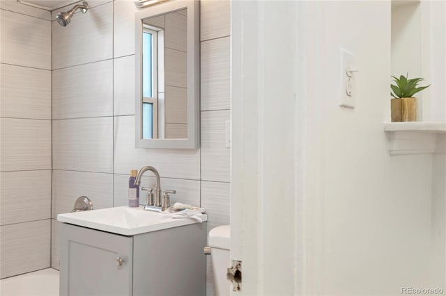 2570 Jay St, Edgewater, CO 80214 - full bath with vanity, toilet, tile walls, and bathing tub / shower combination