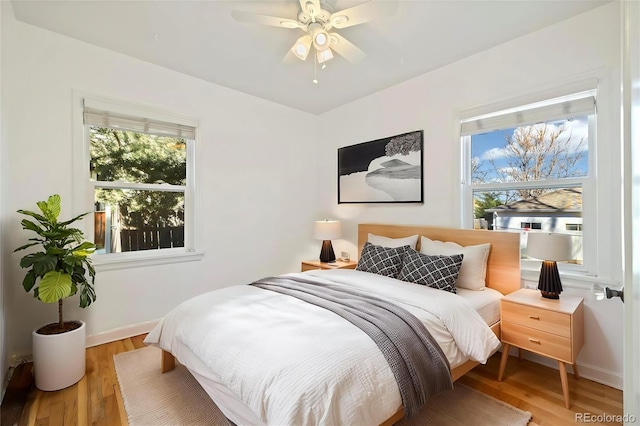 2570 Jay St, Edgewater, CO 80214 - bedroom featuring multiple windows, wood finished floors, and baseboards