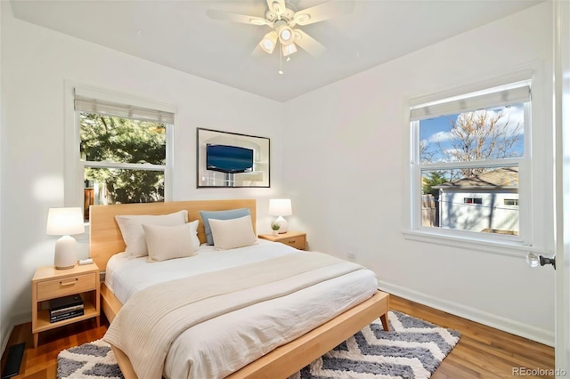 2570 Jay St, Edgewater, CO 80214 - bedroom featuring multiple windows, wood finished floors, and baseboards