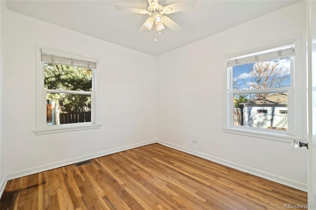 2570 Jay St, Edgewater, CO 80214 - unfurnished room featuring baseboards, healthy amount of natural light, and wood finished floors