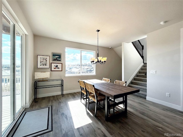 dining area with dark hardwood / wood-style flooring and a notable chandelier