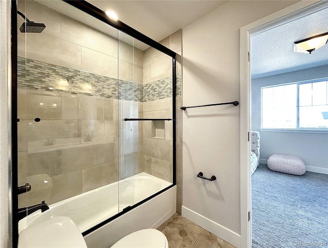 bathroom with bath / shower combo with glass door and toilet