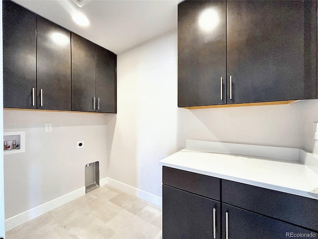 clothes washing area featuring cabinets, hookup for a washing machine, and hookup for an electric dryer