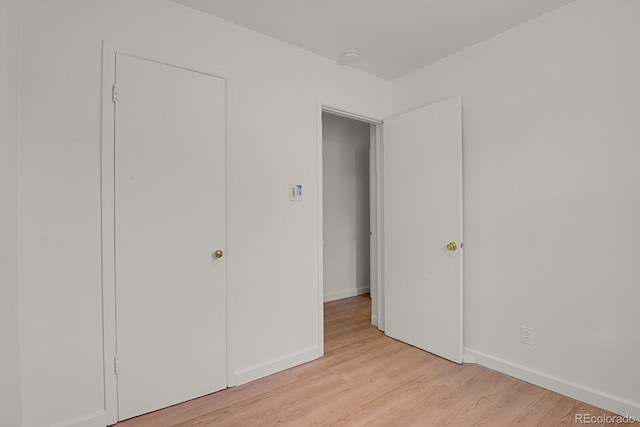 373 S Hazel Ct, Denver, CO 80219 - unfurnished bedroom with light wood-style flooring and baseboards