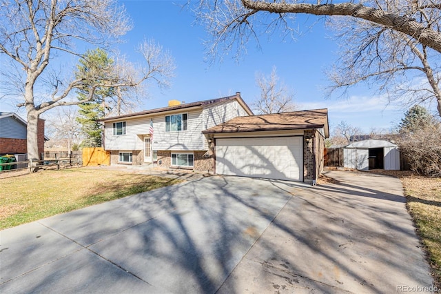 view of front of property featuring a front yard, fence, driveway, an attached garage, and brick siding