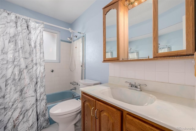 bathroom featuring tasteful backsplash, toilet, shower / bath combo, and vanity