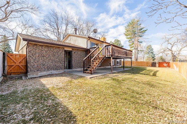 back of property featuring a patio, a fenced backyard, a yard, stairway, and brick siding