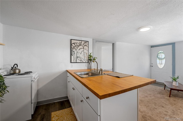 kitchen featuring white electric range, white cabinetry, sink, light hardwood / wood-style floors, and kitchen peninsula