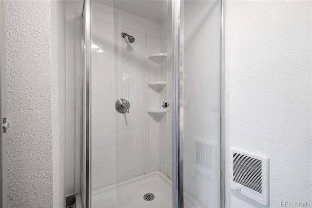 bathroom with a shower with shower door