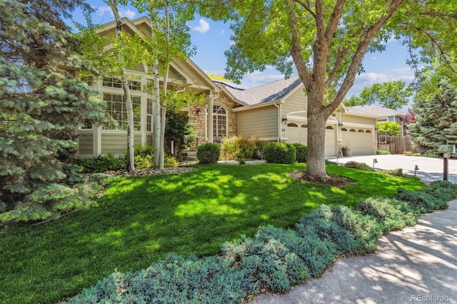 3145 Stevens Cir, Erie, CO 80516 - view of front facade featuring a garage, driveway, brick siding, and roof with shingles
