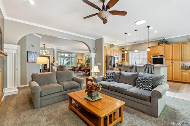 3145 Stevens Cir, Erie, CO 80516 - living room featuring arched walkways, a ceiling fan, healthy amount of natural light, light carpet, and recessed lighting