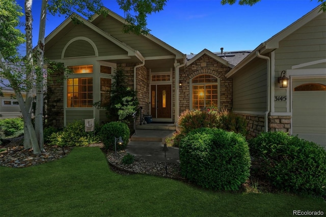 3145 Stevens Cir, Erie, CO 80516 - entrance to property with stone siding, a lawn, and an attached garage