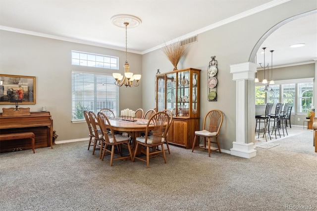 3145 Stevens Cir, Erie, CO 80516 - carpeted dining room with a chandelier, crown molding, and arched walkways