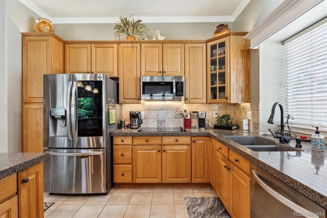 3145 Stevens Cir, Erie, CO 80516 - kitchen featuring appliances with stainless steel finishes, glass insert cabinets, light tile patterned flooring, tasteful backsplash, and dark countertops