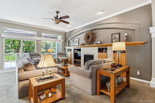 3145 Stevens Cir, Erie, CO 80516 - carpeted living area featuring crown molding, a ceiling fan, and a tiled fireplace